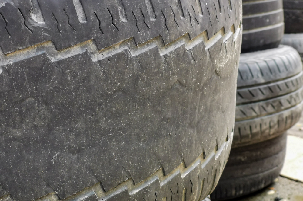 severely worn tires with low tread depth
